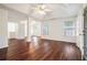 Spacious bedroom with tray ceilings, ceiling fans, neutral walls, and hardwood floors at 1916 Oakwood Grove Dr, Snellville, GA 30078