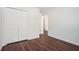 Bedroom features laminate flooring, a closet with bi-fold doors, and white walls at 1916 Oakwood Grove Dr, Snellville, GA 30078