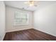 Bright bedroom featuring a window, laminate flooring, and a ceiling fan at 1916 Oakwood Grove Dr, Snellville, GA 30078