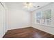 Bright bedroom with a ceiling fan, large window, and laminate flooring at 1916 Oakwood Grove Dr, Snellville, GA 30078