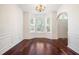 Sunlit dining area featuring a bay window, hardwood floors, and classic wainscoting detail at 1916 Oakwood Grove Dr, Snellville, GA 30078