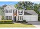 Charming two-story home with black shutters, a brick accent, and a manicured front yard at 1916 Oakwood Grove Dr, Snellville, GA 30078