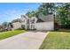 Traditional two-story home boasts a two-car garage, manicured lawn, and lush landscaping at 1916 Oakwood Grove Dr, Snellville, GA 30078