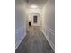 Elegant hallway with gray floors, arched doorway, detailed molding, and an open view to the living room at 1916 Oakwood Grove Dr, Snellville, GA 30078