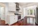 Kitchen with stainless steel appliances, granite countertops, and white cabinets, adjacent to breakfast area with bay window at 1916 Oakwood Grove Dr, Snellville, GA 30078