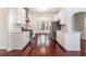 Bright kitchen features stainless steel appliances and white cabinetry overlooking breakfast nook with large windows at 1916 Oakwood Grove Dr, Snellville, GA 30078