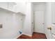 Clean laundry room features white walls, wooden floors, and shelving units with storage space at 1916 Oakwood Grove Dr, Snellville, GA 30078