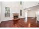 Spacious living room with hardwood floors, a cozy fireplace, and large windows for ample natural light at 1916 Oakwood Grove Dr, Snellville, GA 30078