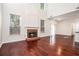 Bright living room with a brick fireplace, hardwood floors, and large windows at 1916 Oakwood Grove Dr, Snellville, GA 30078