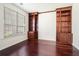 Cozy office space featuring hardwood floors, large window, and built-in bookshelves at 1916 Oakwood Grove Dr, Snellville, GA 30078