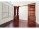 Bright office space featuring custom built-in bookshelves, hardwood floors, and a large window at 1916 Oakwood Grove Dr, Snellville, GA 30078