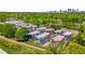 An aerial view of a vibrant townhome community surrounded by lush greenery and a distant skyline at 383 Pratt Se Dr # 504, Atlanta, GA 30315