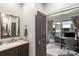 Clean bathroom with a vanity, large mirror, and access to the bedroom's workspace and balcony at 383 Pratt Se Dr # 504, Atlanta, GA 30315