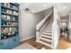 Hallway with staircase, built-in blue shelving, and stylish hardwood floors at 383 Pratt Se Dr # 504, Atlanta, GA 30315