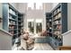Inviting library features custom blue built-in bookshelves, a window seat, and cozy armchair at 383 Pratt Se Dr # 504, Atlanta, GA 30315