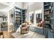 Stylish library with built-in blue bookcases, window seat, and cozy reading area at 383 Pratt Se Dr # 504, Atlanta, GA 30315