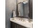 Elegant powder room with geometric wallpaper, modern sink, and stylish mirror at 383 Pratt Se Dr # 504, Atlanta, GA 30315