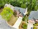 Aerial view of a brick home with mature landscaping, a paved driveway, and a well-maintained lawn at 4223 Millside Se Walk, Smyrna, GA 30080