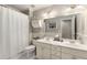 Bright bathroom featuring a double sink vanity, ample lighting, and a shower with a clean white curtain at 4223 Millside Se Walk, Smyrna, GA 30080