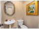 Elegant powder room with decorative mirror and pedestal sink enhances this beautiful home at 4223 Millside Se Walk, Smyrna, GA 30080
