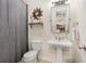 Cozy bathroom featuring a pedestal sink, decorative mirror, and adjacent shower area at 4223 Millside Se Walk, Smyrna, GA 30080