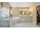 Luxurious primary bath with double vanity, soaking tub, and frameless shower provides a relaxing oasis at 4223 Millside Se Walk, Smyrna, GA 30080