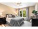 Comfortable bedroom with calming colors, large window, and curated decor exudes cozy warmth at 4223 Millside Se Walk, Smyrna, GA 30080