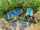 Aerial view showcasing a community pool and tennis court surrounded by lush greenery and mature trees at 4223 Millside Se Walk, Smyrna, GA 30080
