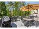 Outdoor deck with patio table set, grill, and wooded views, perfect for outdoor dining and entertaining at 4223 Millside Se Walk, Smyrna, GA 30080