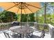 Outdoor deck features an umbrella-covered table and chairs, perfect for enjoying the surrounding lush greenery at 4223 Millside Se Walk, Smyrna, GA 30080