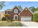 Charming two-story brick home with well-manicured lawn and attached two-car garage at 4223 Millside Se Walk, Smyrna, GA 30080