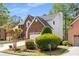 Charming front exterior features brick accents, a well-manicured lawn, and a two-car garage at 4223 Millside Se Walk, Smyrna, GA 30080