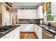 Well-lit kitchen showcasing white cabinetry, dark countertops, and an undermount stainless steel sink at 4223 Millside Se Walk, Smyrna, GA 30080