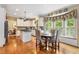 Spacious kitchen leading into a dining area, with hardwood floors and modern lighting at 4223 Millside Se Walk, Smyrna, GA 30080