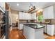 A stylish kitchen boasts white cabinets, a central island with a cooktop, and stainless steel appliances at 4223 Millside Se Walk, Smyrna, GA 30080