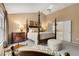Spacious main bedroom features a four poster bed and an en-suite bathroom with a soaking tub at 4223 Millside Se Walk, Smyrna, GA 30080