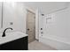 Modern bathroom featuring subway tile in shower and black fixtures, with a gray vanity at 5017 Spring Hill Dr, Sugar Hill, GA 30518