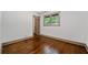 Bedroom with hardwood floors, window, and neutral paint at 5017 Spring Hill Dr, Sugar Hill, GA 30518