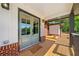 Inviting front porch with a light green double door and 