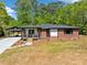 Charming brick home with a covered carport and newly landscaped front yard at 5017 Spring Hill Dr, Sugar Hill, GA 30518