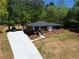 Attractive brick home features a carport, inviting entrance, and mature trees at 5017 Spring Hill Dr, Sugar Hill, GA 30518