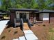 Attractive brick home with modern accents, inviting entry steps, and a convenient covered carport at 5017 Spring Hill Dr, Sugar Hill, GA 30518