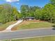 A charming home with a long driveway, carport, and well-manicured lawn at 5017 Spring Hill Dr, Sugar Hill, GA 30518