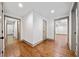 Hallway with hardwood floors and doorways leading to various rooms at 5017 Spring Hill Dr, Sugar Hill, GA 30518