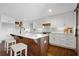 Modern kitchen with island and bar seating, showcasing stainless appliances, and stylish countertops at 5017 Spring Hill Dr, Sugar Hill, GA 30518