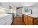 Beautiful kitchen with a large island, stainless steel appliances, white cabinetry and hardwood floors at 5017 Spring Hill Dr, Sugar Hill, GA 30518