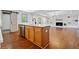 Open-concept kitchen with an island, stainless steel appliances, and seamless flow into the living area at 5017 Spring Hill Dr, Sugar Hill, GA 30518