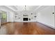 Sunlit living room with fireplace, hardwood floors, built-in shelving, and recessed lighting at 5017 Spring Hill Dr, Sugar Hill, GA 30518