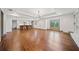 Spacious living room featuring hardwood floors, recessed lighting, fireplace and bar seating area at 5017 Spring Hill Dr, Sugar Hill, GA 30518