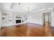 Bright living room with hardwood floors, built-in shelving, white brick fireplace, and recessed lighting at 5017 Spring Hill Dr, Sugar Hill, GA 30518